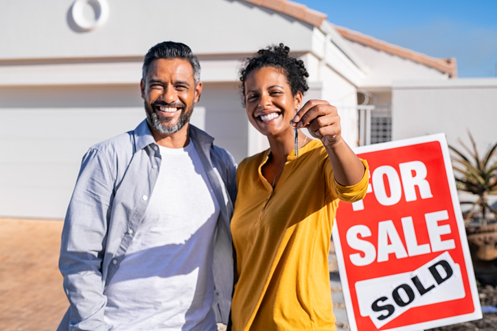 Ethnic couple holding new house keys